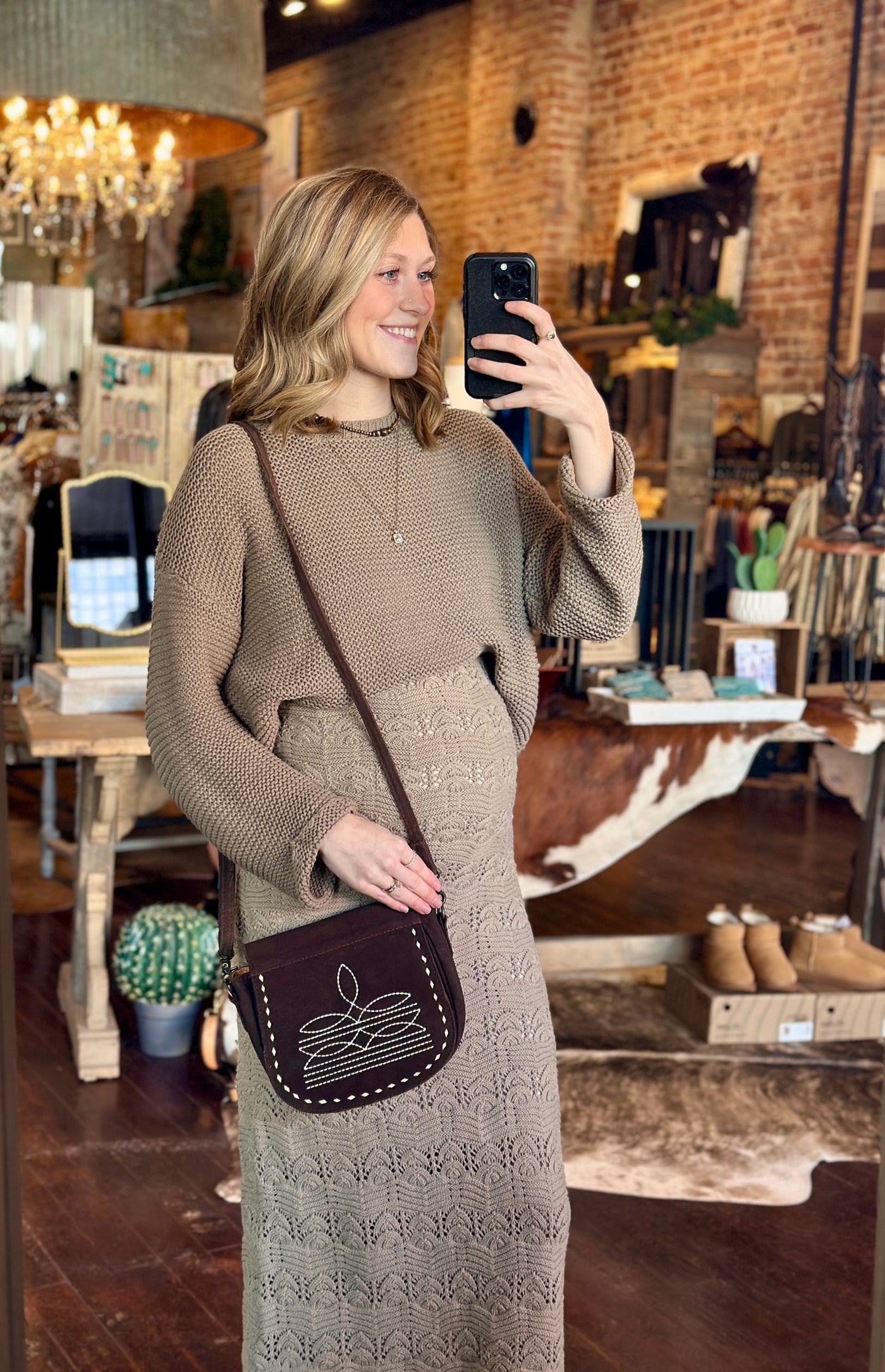 Skippy Leather Crossbody Styled with a Western Mocha Mousse Sweater - modeled by employee to show size relevance.