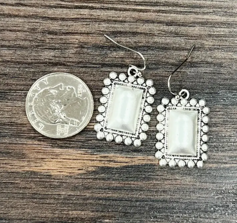 Stock photo showing our Snap On Boho Silver Earrings next to a quarter for size reference.