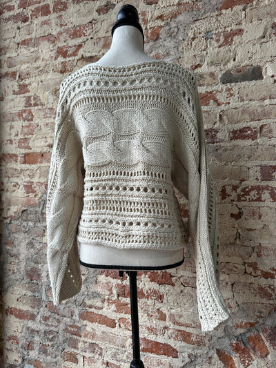 Full view of the Squirrel Cable Knit Sweater, showcasing its comfortable fit and fashionable design.