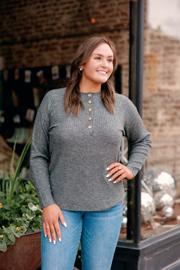 Model showing lightweight and versatile buttoned sweater for casual and dressy occasions.