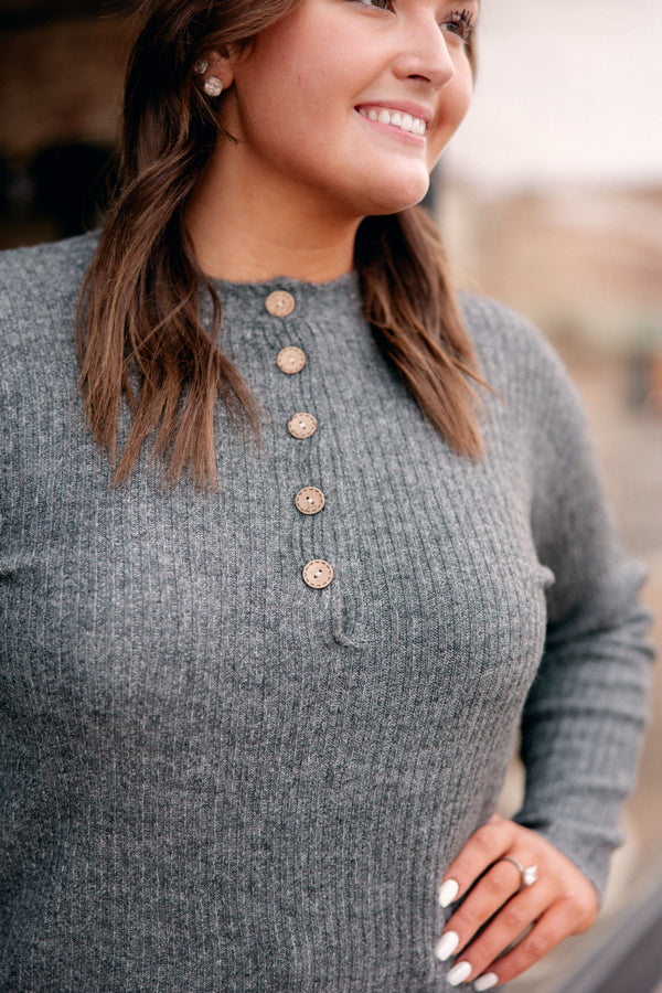 Close-up of the button details on the Take Me To Church sweater, adding a rustic touch.