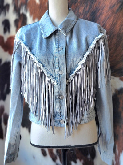 Tessa Fringe Denim Jacket with cropped fit and trendy fringe detailing Available Now at Broker Leather downtown Waukon, Iowa.