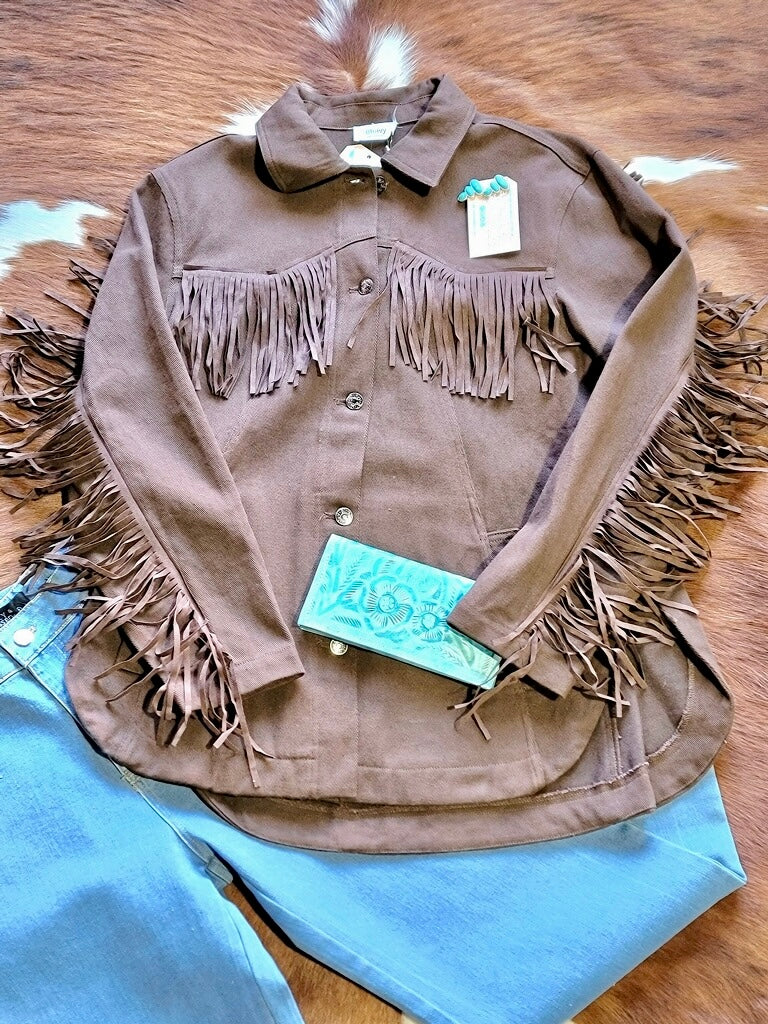 Western-inspired denim jacket with statement fringe and classic fit.