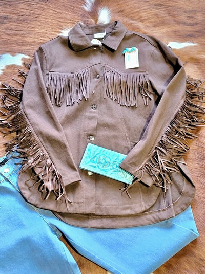 Western-inspired denim jacket with statement fringe and classic fit.