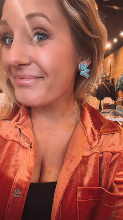 Western-themed Topo Chico Earrings featuring faux turquoise stones and unique texture on model from Broker Leather.