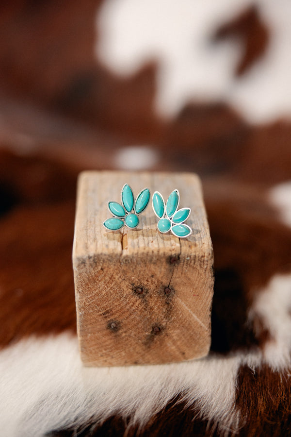 Turquoise cluster earrings styled for honky tonk nights or professional looks.