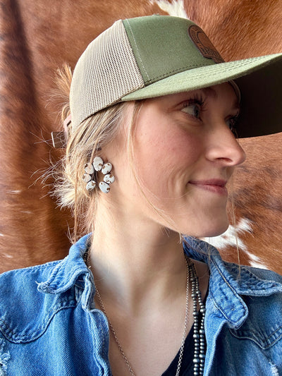 Torrington Clay Cluster Earring [White] modeled by Broker Leather employee, are one-of-a-kind polymer clay earrings measuring 1.5 inches tall and wide, perfect for Western styling.