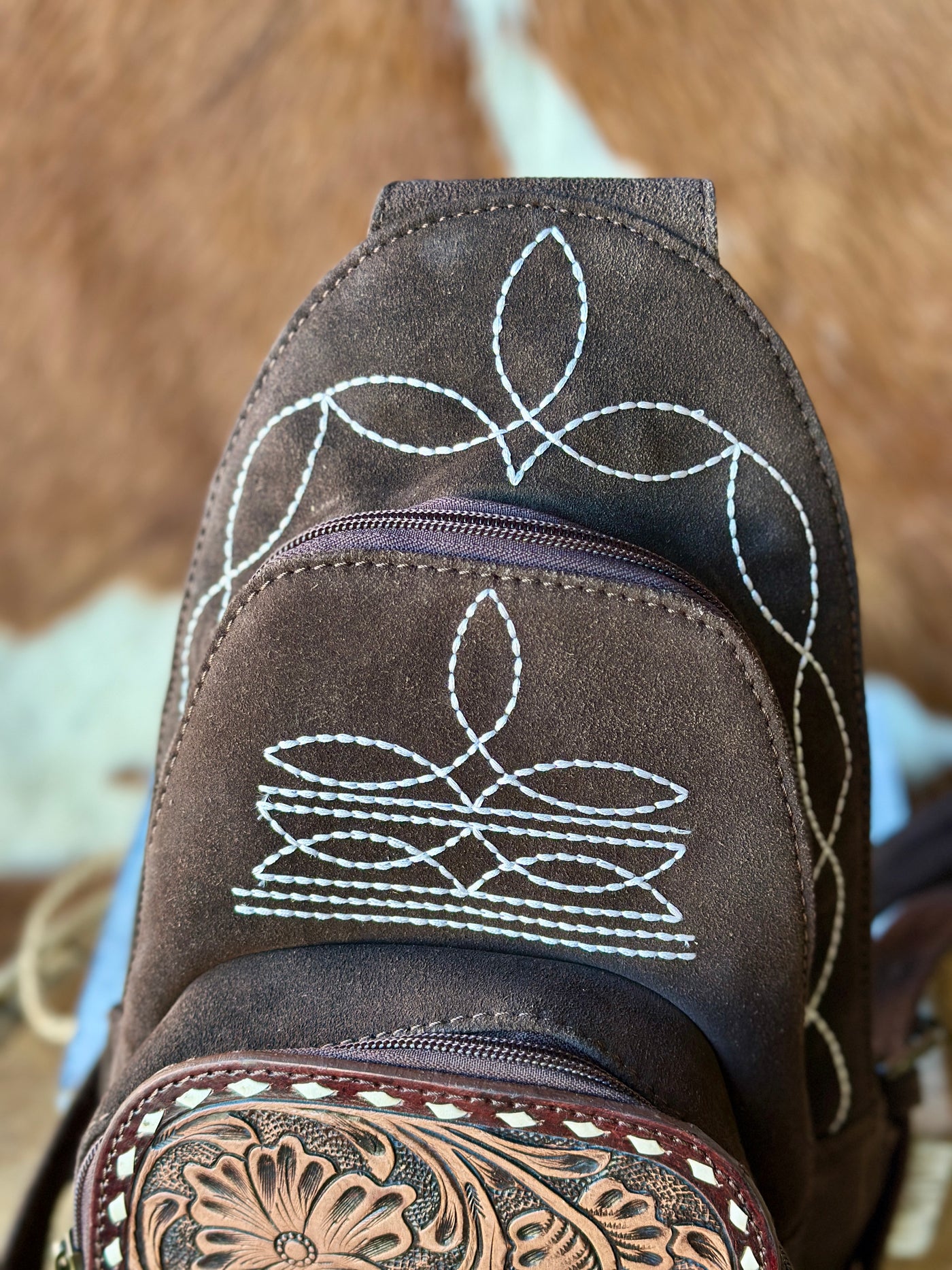 Close-Up of Treaty Suede Leather Backpack with Tooled Leather Accents.