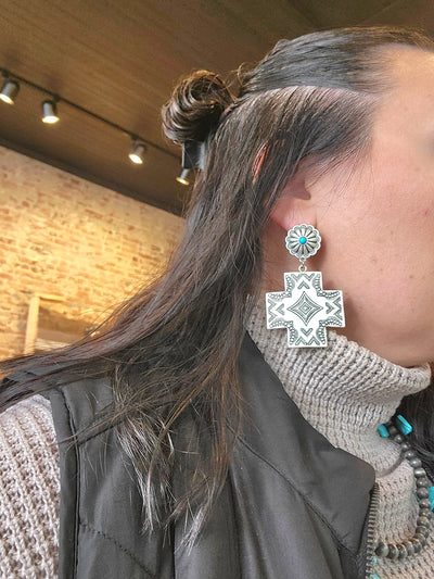 Closeup of a woman modeling our Trina Metal Aztec Post Earrings.