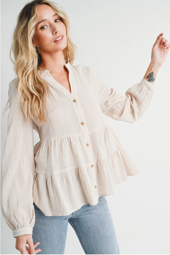 Boho-inspired tiered blouse styled for effortless elegance and versatility.