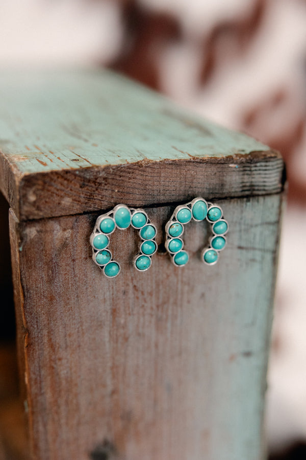 Close-up of Trisha Squash Post Back Earrings showcasing Western-inspired Squash Blossom shape of faux turquoise stones.