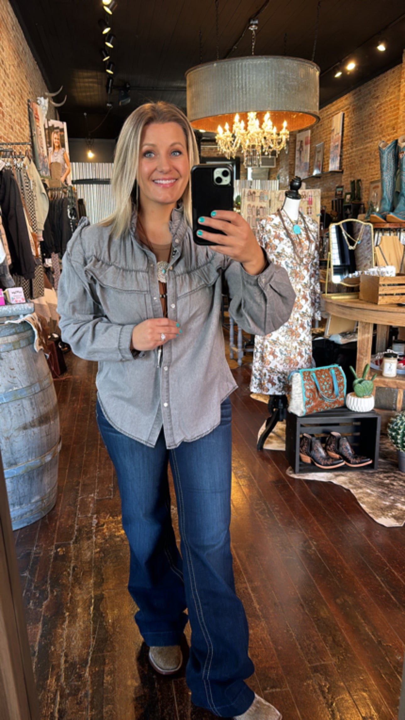 Model at Broker Leather in light grey Voyager Ruffled Denim Shirt styled for a casual yet refined look, perfect for any adventure.