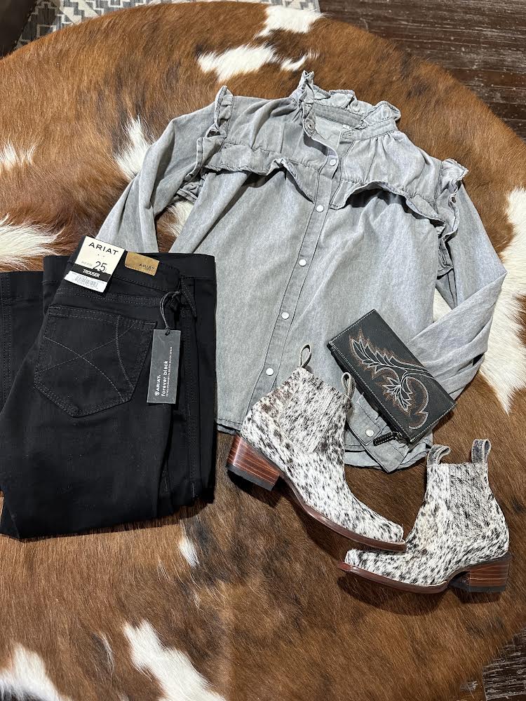 Flat lay of the Voyager Ruffled Denim Shirt at Broker Leather, highlighting its ruffles, pearl snaps, and versatile grey hue.