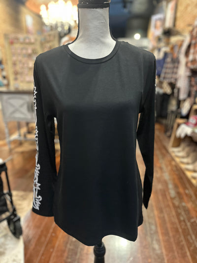 Full view of the Walton Long Sleeve Top, demonstrating the elegant blend of black fabric with bold cream stitching.