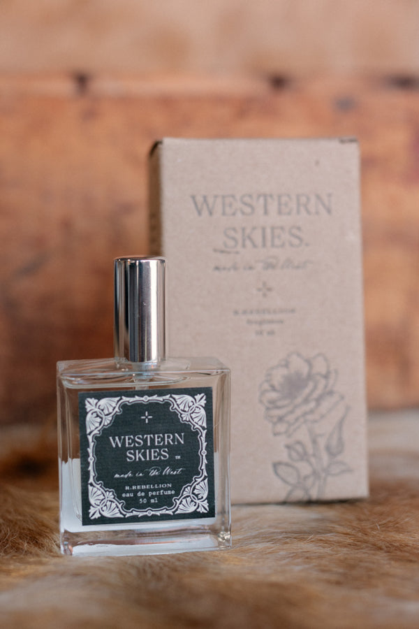 Styled image of the spray perfume alongside rustic Montana-inspired decor, capturing its Western charm.