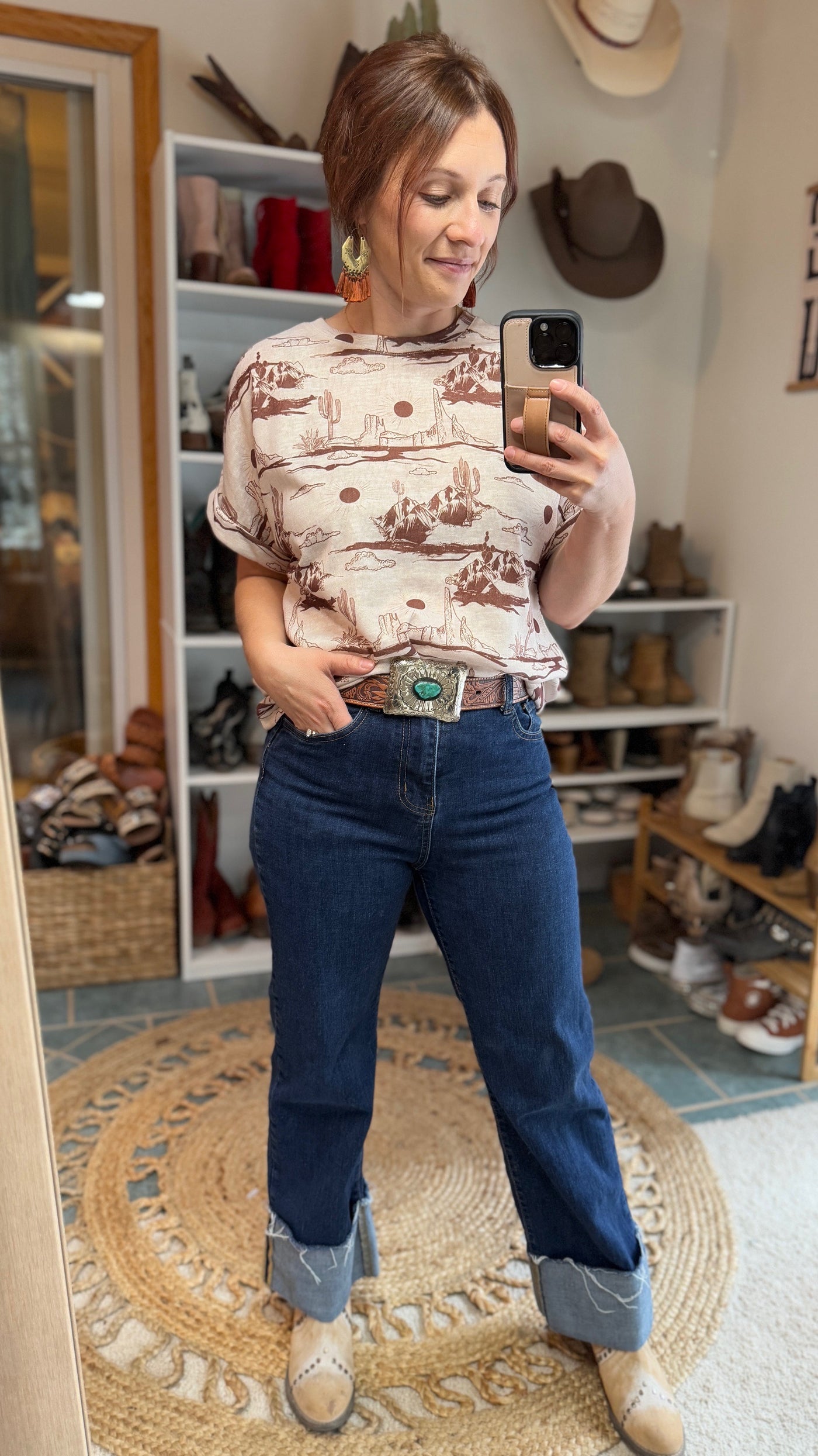 Model wearing Wren Desert Scene top paired with denim and boots.