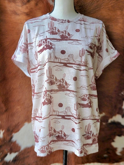 Wren Desert Scene Top with a crisp white base and earthy brown desert landscape print, perfect for summer adventures.