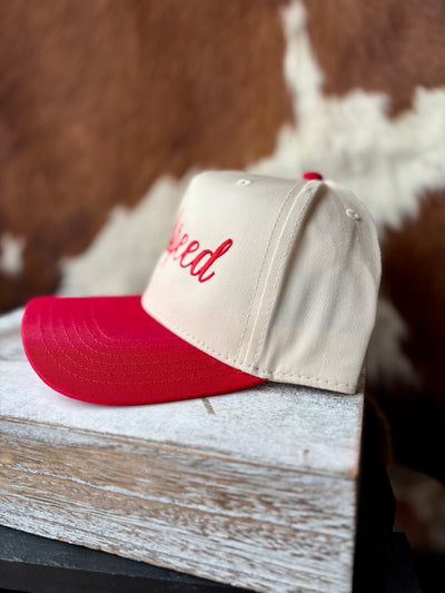 Side profile of the Zach Godspeed Cap, showcasing its structured 5-panel design and matching red visor.