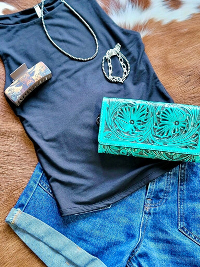 Outfit inspiration flatlay featuring a basic tank top, denim shorts, Navajo Pearl necklace and a Western Leather Crossbody Clutch.