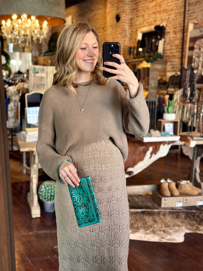 Tooled Leather Clutch with Wristlet Strap – A beautifully tooled leather clutch with a removable wristlet strap, featuring intricate floral detailing.