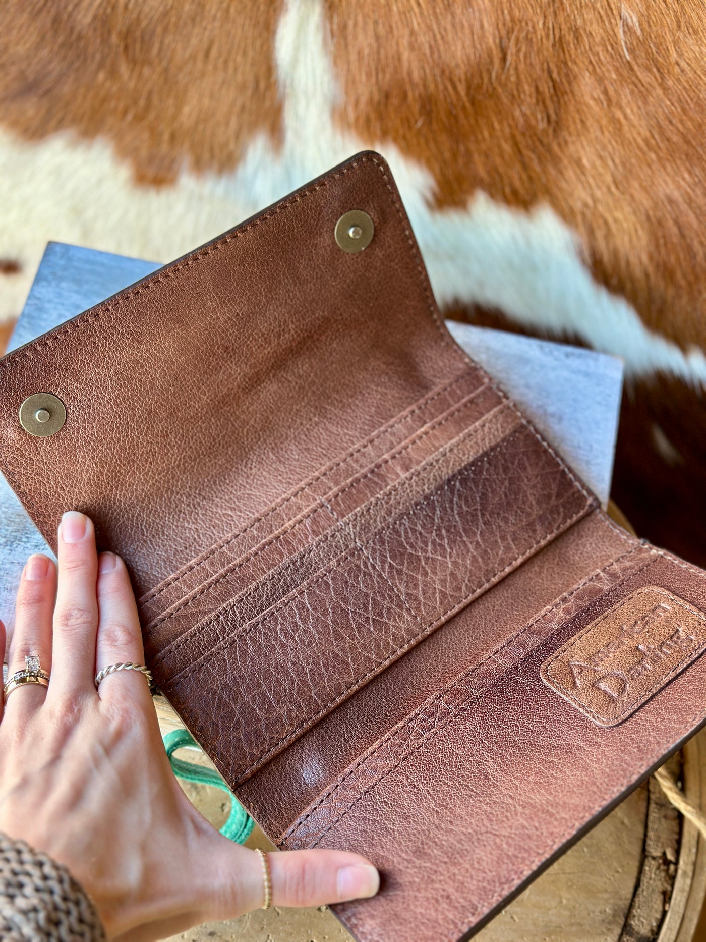 Open Tooled Leather Wallet with Card Slots – Interior view of the clutch showing 10 credit card slots, two cash slots, and a magnetic closure.