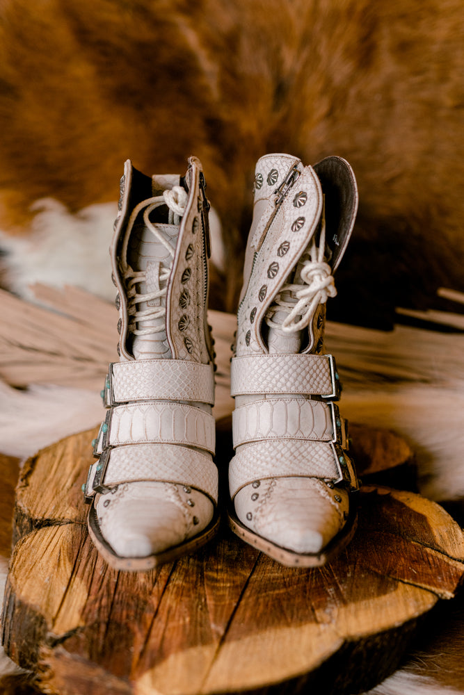 Front view of snip toe Lane Showdown Boots in ceramic crackle white with laced corset and non-adjustable buckles.