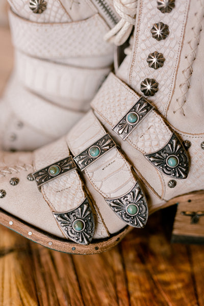 Close-up of Lane Showdown Buckled Boots showcasing gorgeous sterling silver rondelle studs and buckle strap details.