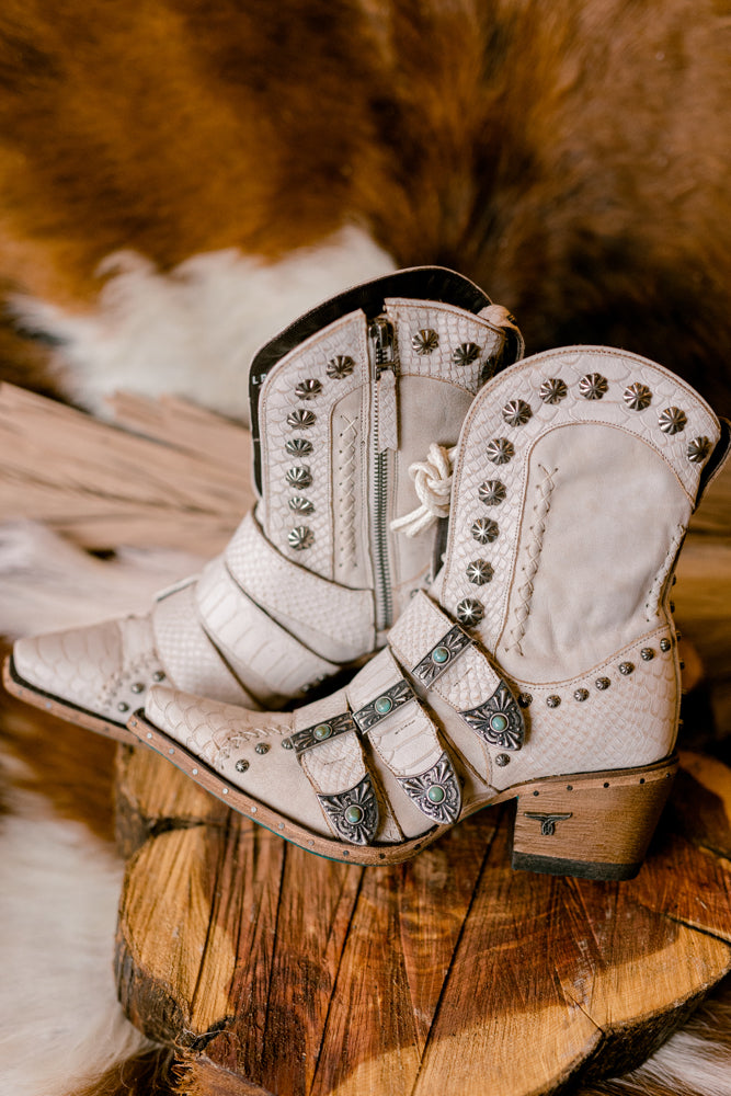 Side profile of Lane Showdown Buckled Boots with easy on-and-off side zipper and chic snip toe available at Broker Leather.