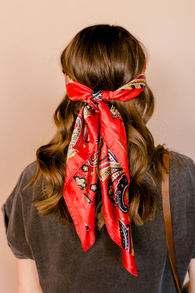 Another rear view of a woman modeling the Welsh Red Paisley Wild Rag as a head wrap.